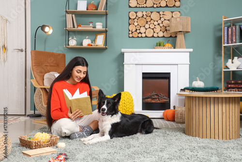 Young woman reading book wi...