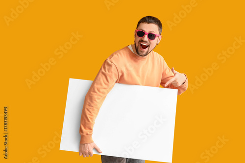 Young man in sunglasses poi...