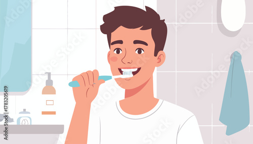 A young man is brushing his teeth in a bathroom with a sink, mirror, and towel.