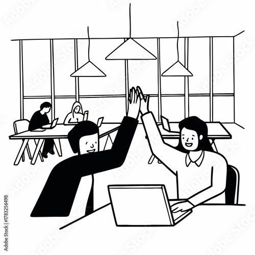 Successful business people giving each other a high five while working on laptop in coworking