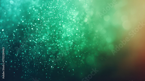 Magical abstract green background with dusty glitter and sparkle bokeh