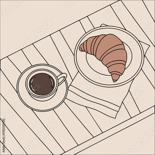 A cup of coffee and a croissant on a table, ready for a delicious breakfast