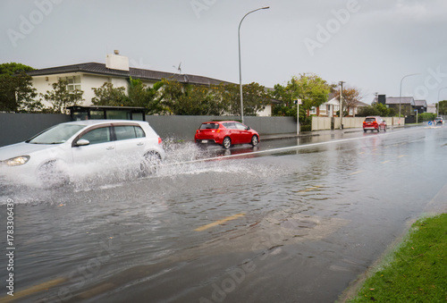 Car driving through floodwater after heavy rain. Auckland. New Zealand.