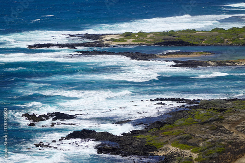 Fotografie Wide coastal panorama with reef filled shallows and breaking surf lines