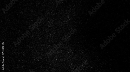 Atmospheric Dust Particles Floating on Black Background