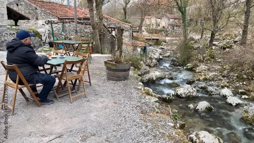 Wallpaper Mural Hombre tomando café al lado del río en Bulnes, Asturias Torontodigital.ca