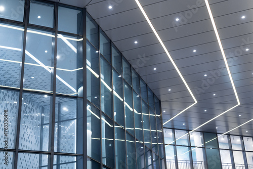 Canvastavla Modern building interior with glass walls and linear LED ceiling lights