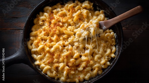 Creamy mac and cheese in rustic skillet, culinary nostalgia, comforting autumn festival delight, celebration of rich, cheesy indulgence