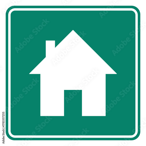 Haus und grünes Schild