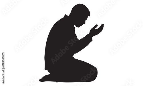 Man kneeling in prayer silhouette