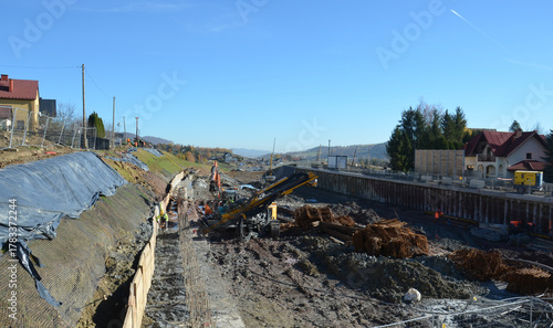Installation of ground anchors on a mountain slope – slope stabilization and reinforcement works during railway line construction. Visible drilling rigs, steel anchors lk104.