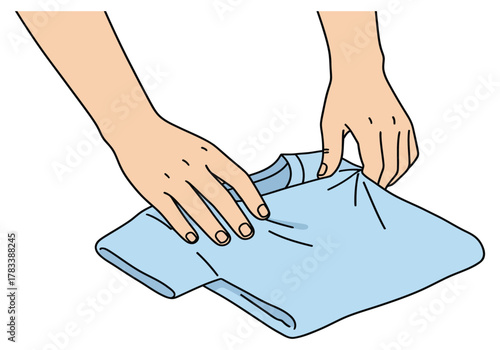 An illustration of two hands carefully folding a light blue t-shirt on a white background.