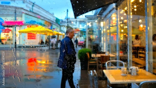 Urban café seen through rain-speckled glass, reflections of lights and people, emotional distance, cinematic tone.