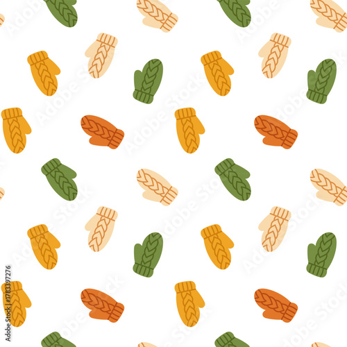 Vector seamless pattern with cute knitted mittens in orange, beige, green, and yellow on white background. Cozy winter print for wrapping paper, textile, and seasonal design.