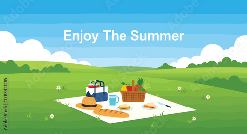 Enjoying a summer picnic with food and drinks on a checkered blanket in a green meadow with rolling hills and blue sky.