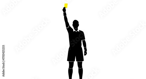 Silhouette of a male soccer football referee holding up a yellow card, signaling a warning or foul during a match, indicating a disciplinary action.