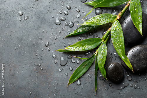 Zen-like spa scene with vibrant green bamboo leaves, smooth black stones, and water droplets for wellness and tranquility