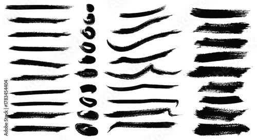 A comprehensive set of black grunge ink brush strokes, including lines, dots, and various hand-drawn textures, isolated for modern artistic graphic design projects.