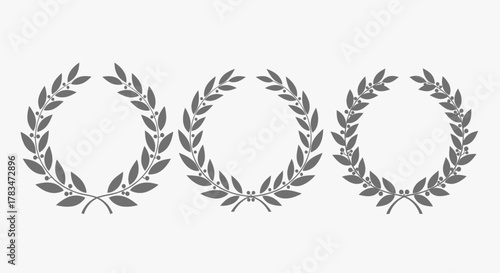 A set of three grey laurel wreath icons, classic symbols of victory, honor, and achievement, on a plain background.