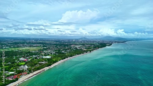 senggigi beach coastline with stormy clouds over the ocean and townscape senggigi