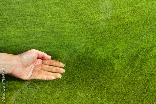 The woman dipped her hand into the water with blooming algae