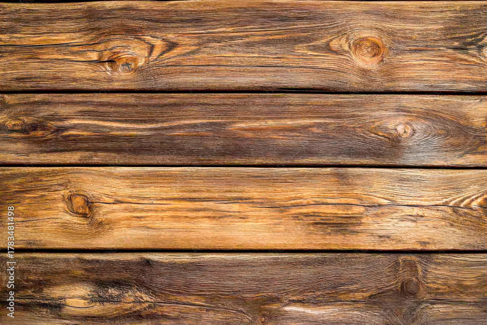 Obraz premium Close-up view of a rustic wooden surface, highlighting the unique textures and rich tones of the wood grain in natural light