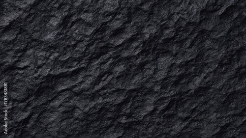 Close-up of dark slate stone texture showcasing natural roughness and subtle shading. Deep gray tones create rugged appearance. Unlit, enhancing surface detail. Neural network AI generated