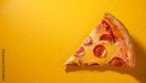 slice of pizza on bright yellow background for food advertising