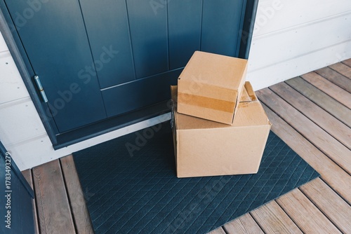Fotografie A Stacked Arrangement of Cardboard Boxes Waiting on a Doorstep, Showcasing the C