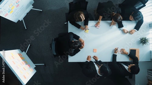 Photos Top down aerial view of businesswoman give sticky notes to participant before start meeting