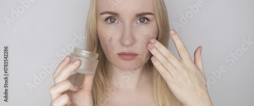 Microplastics in cosmetics. A woman applied a care cream to her skin, now it is covered with plastic particles and microbeads. Cosmetics toxicity concept