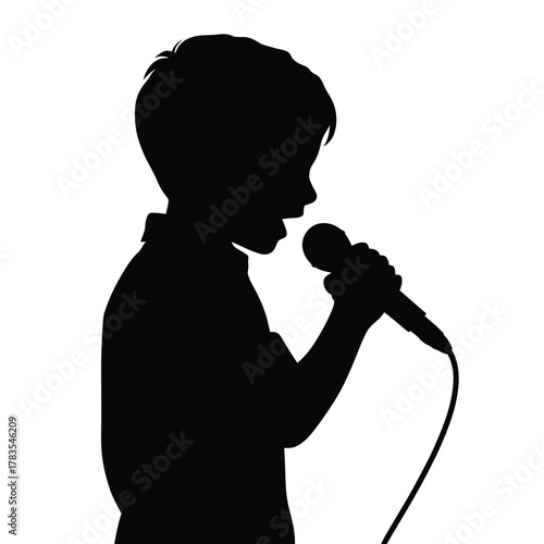 Silhouette of a young boy singing into a microphone