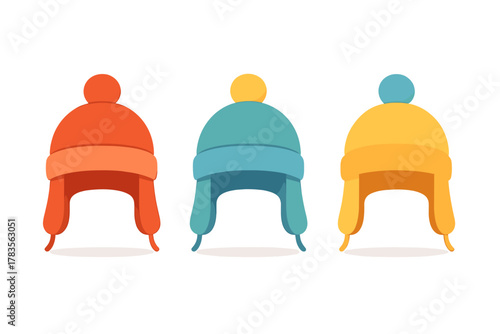 Three colorful winter trapper hats with ear flaps and pom-poms isolated on white background