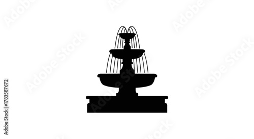 Black silhouette of a threetiered outdoor fountain with arching streams of water