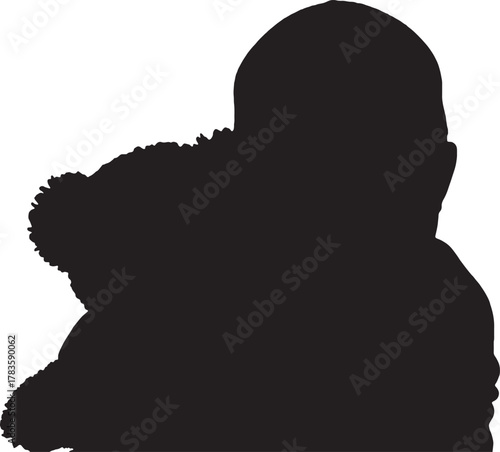 Silhouette of a man wearing a winter coat with fur hood