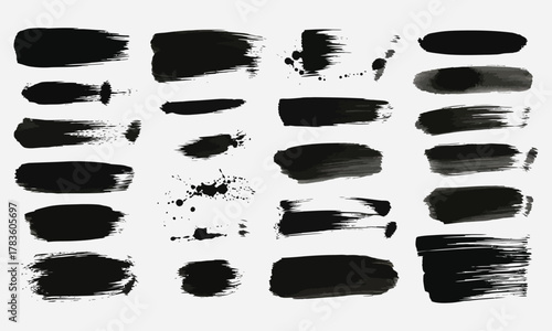 Collection of abstract black brush stroke elements and splatters for artistic design applications