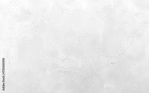 Texture of a concrete wall with cracks and scratches which can be used as a background. White concrete wall texture