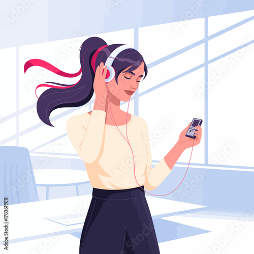 A young woman with headphones enjoys music, gazing thoughtfully while standing in a bright office space with large windows and slight ambient light, promoting relaxation and focus.