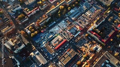 Backward drone shot pulling away from Central Market with panoramic view of downtown Chisinau at sunset