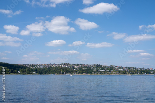 Panoramic view of Langscheid village, part of Sundern city in Sauerland, North Rhine-Westphalia, Germany, seen from the Sorpe Reservoir, scenic landscape, copy space.