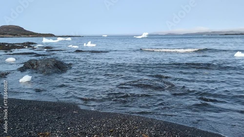 Floating iceberg in the Hay cove close to l'Anse aux Meadows National Historic Site (Hay Cove, Newfoundland, Canada)