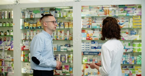 friendly pharmacist advising customer, professional interaction between pharmacist and customer