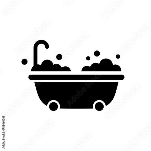 Solid icon of a bubble bath in a freestanding bathtub with a running faucet