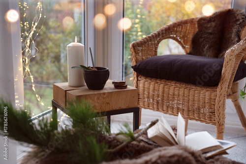 Cozy reading nook with comfortable furnishings and natural light. Background for leisure and relaxation.