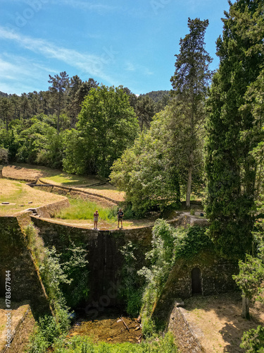 Couple Exploring the Historic Lucca Aqueduct Bridge in Tuscany, Italy