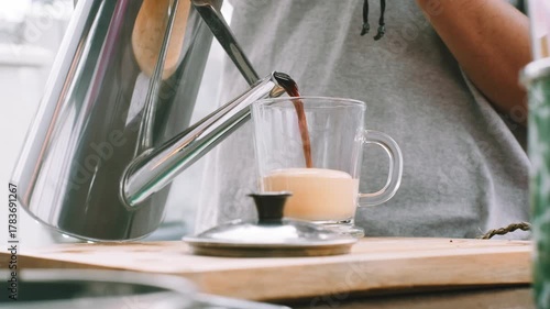 Pouring coffee to make Vietnamese egg coffee