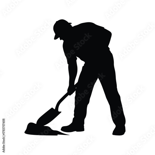 Silhouette of a construction worker digging with a shovel