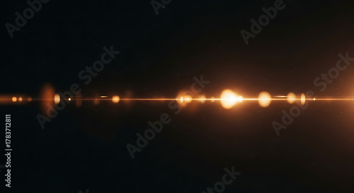 Golden light streak with lens flare effect shining across a dark starry space background creating a dramatic and cinematic visual experience for designs