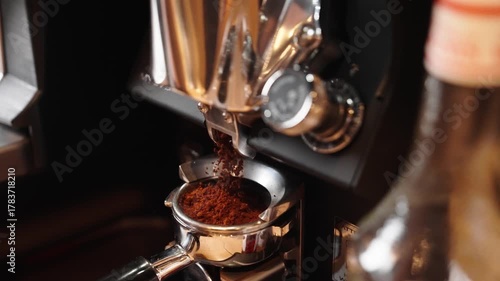 ground coffee is poured into a coffee machine to make fresh coffee in a coffee shop or restaurant in slow motion vertical video