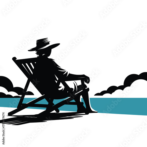 Silhouette of person in deck chair at the beach watching the ocean
